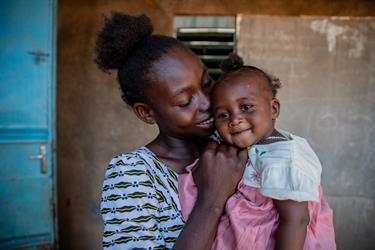 Mom and baby smiling together.