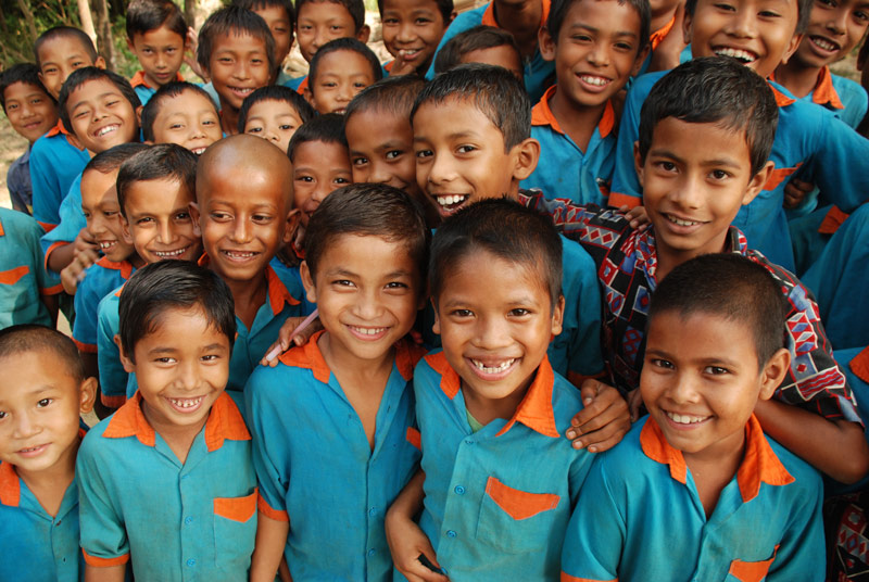 A group of children smile for the camera