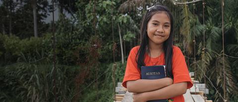 a girl holds her Bible