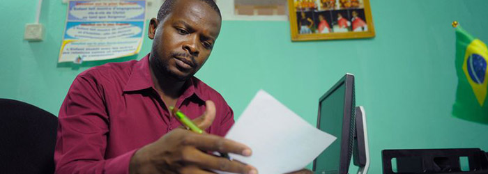 A Compassion employee works on paperwork