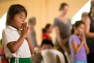 Children praying in a church