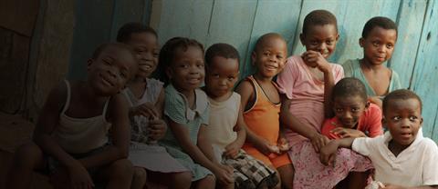 Children sitting outside together in Ghana