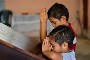 Two boys pray