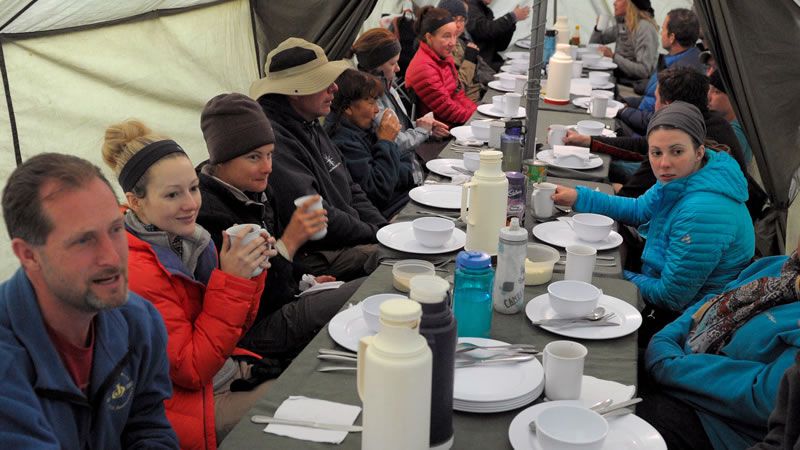 Climbers eat in a dining tent that was pitched at mealtimes