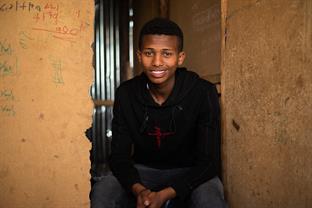 Mikiyas smiles at the camera