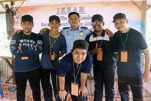 Ryand stands with the young men that he mentors