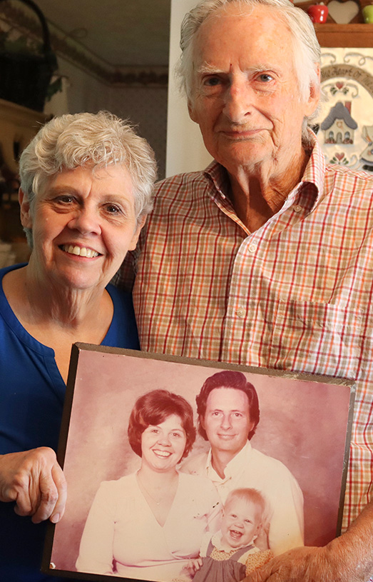 Richard and Lois hold an old family photo