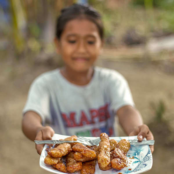 a girl holds a plate of food