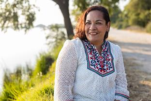 Belen sits by a lake
