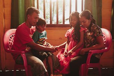 a family prays in their home
