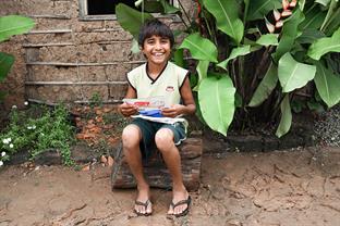 a boy reads letters from his sponsor