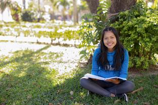 Maria sits and reads a book