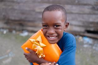 a boy holds a gift