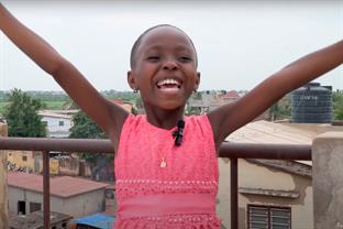 a girl raises her hands in celebration
