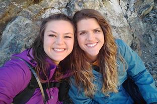 2 girls rest during a hike