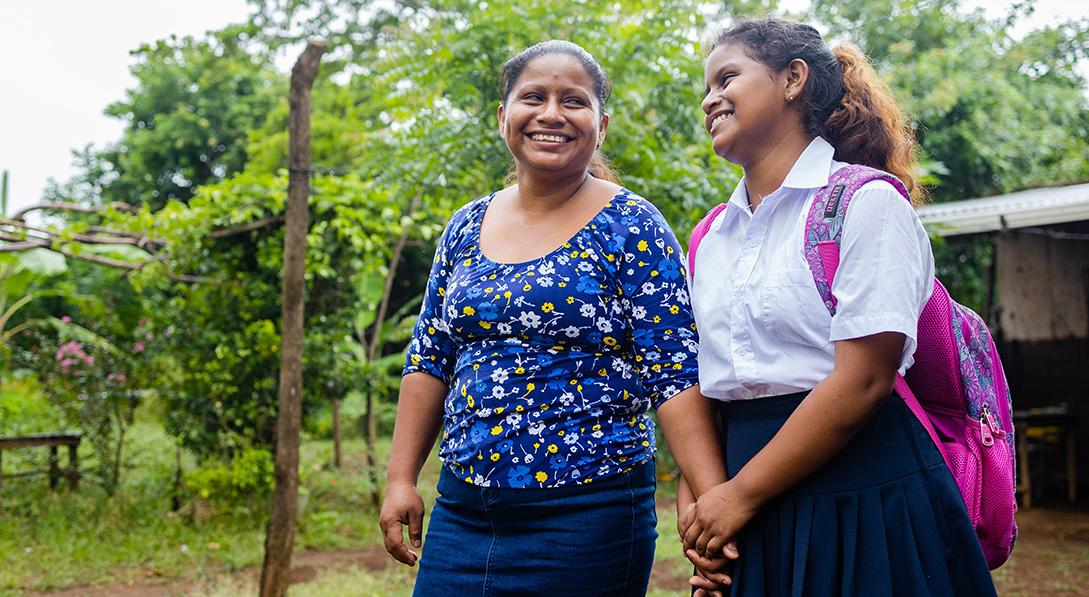 Crisli is ready to go to school, as she stands with her mother