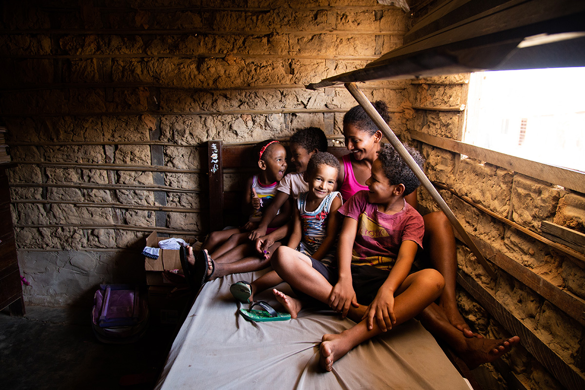 a mother sits in her house with her children