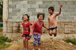 3 children jump and laugh