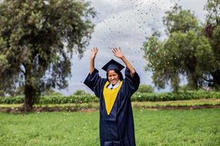 a graduate celebrates
