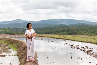 Natlada is standing near water