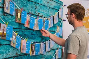 a guy points at child packets on the wall