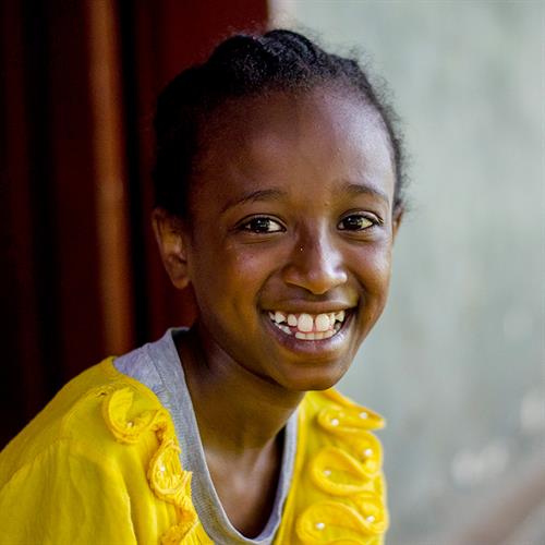 a girl smiles at the camera