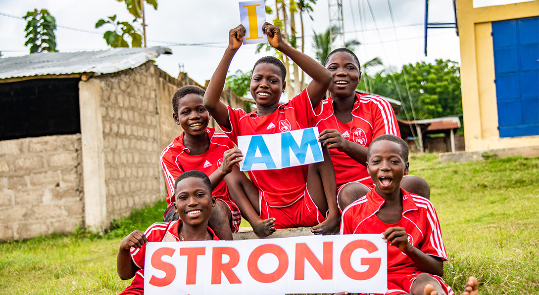 Children holding up a sign saying I am strong