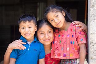 Mom stands with her two children