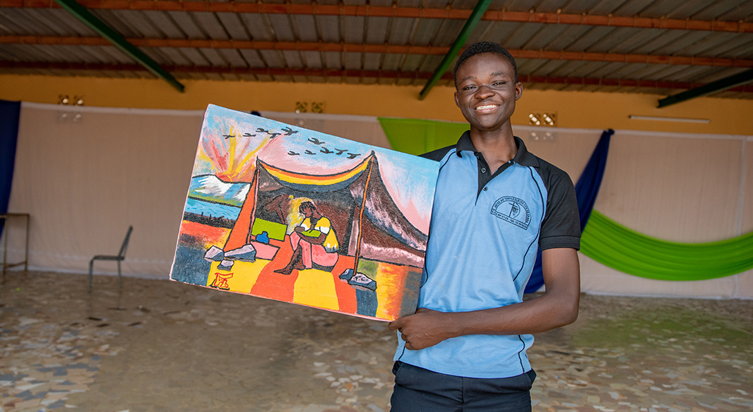 Fabrice holding up image that was painted