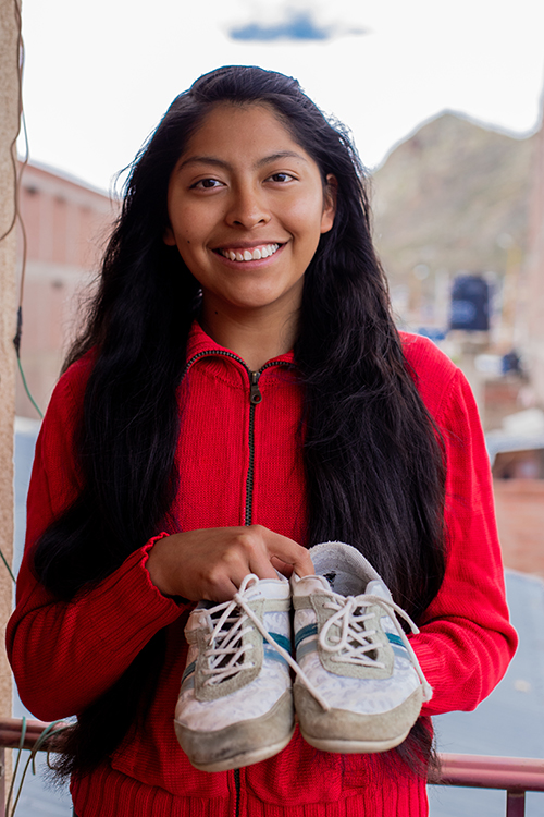 Marcela holding shoes