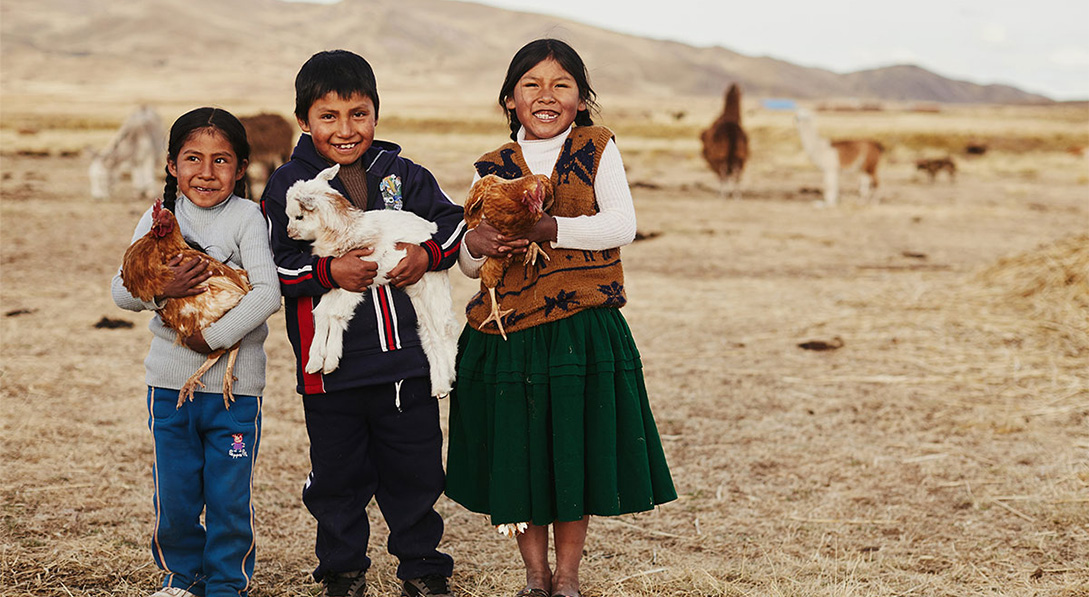 children smiling holding animals