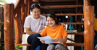 girl smiles while reading letter