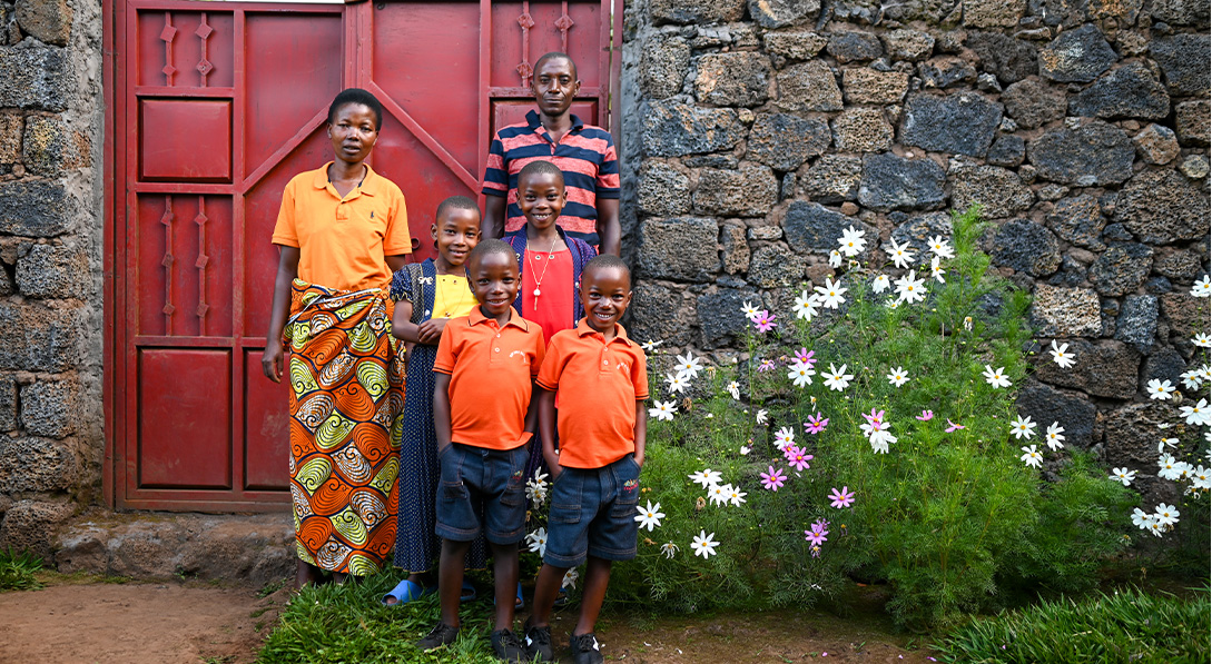 Twins and their family in front of flowers and stone background