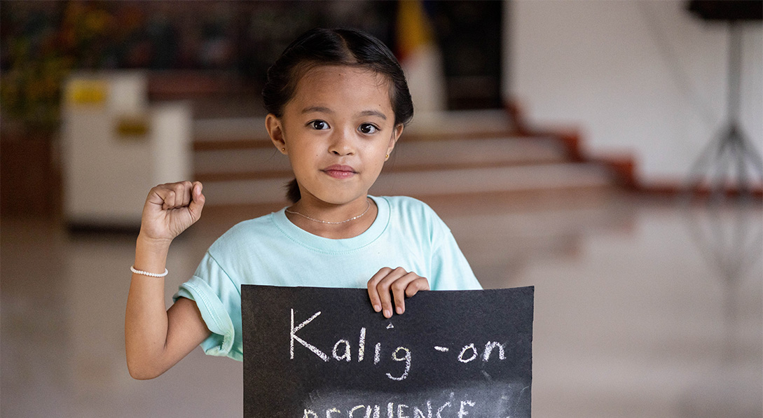 Althea holds sign that says "resilience"