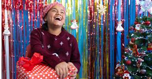 child smiles while holding gift