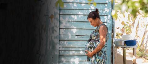 A pregnant woman standing outside
