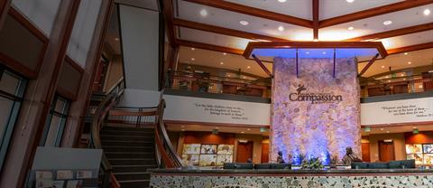Compassion main lobby with rock wall and Compassion logo