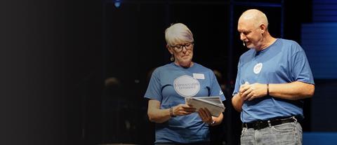 A man and woman wearing blue Compassion Sunday t-shirts