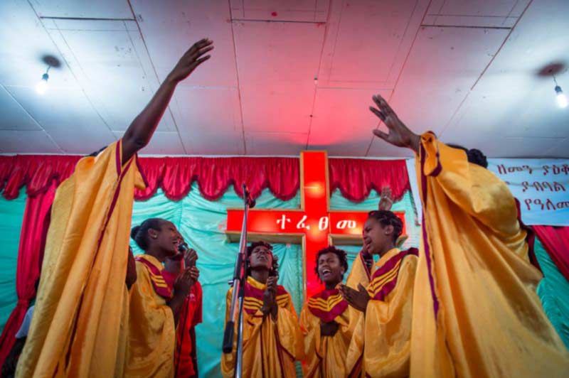 A group of women wearing choir robes during a worship service