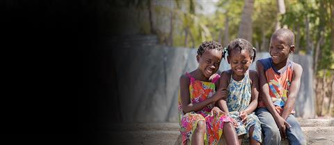 Row of children sitting and smiling