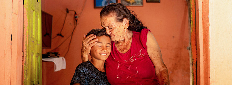 a grandmother kisses her grandson