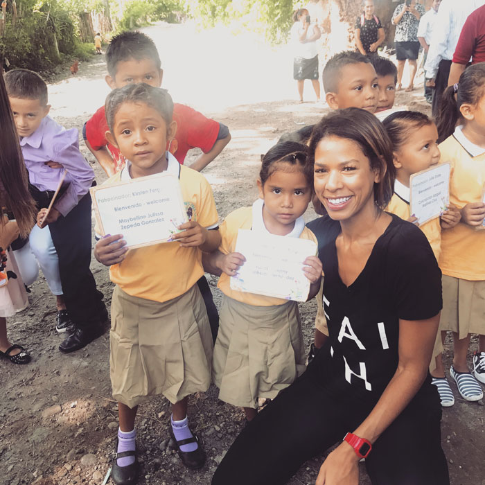 Kirsten smiles and poses with Compassion sponsored children