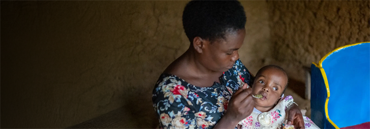 A mother feeding her baby with a spoon