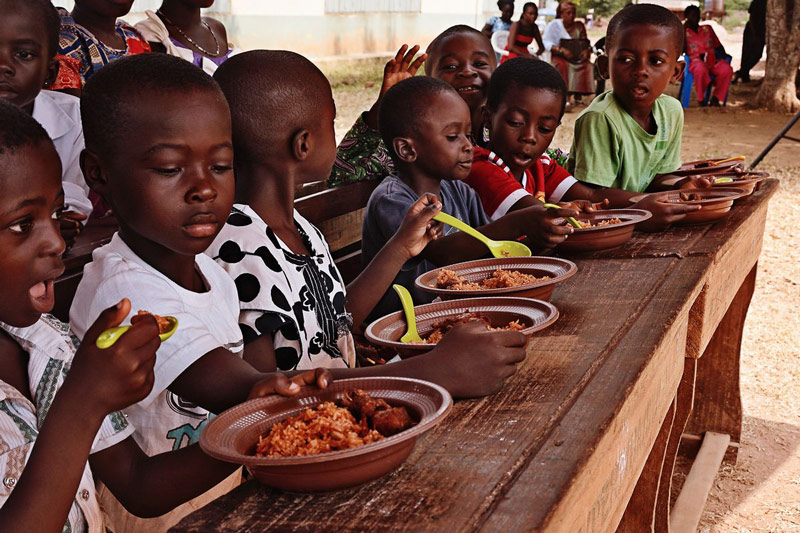 A group of children are ready to enjoy a special Christmas meal