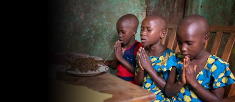 3 girls pray before eating