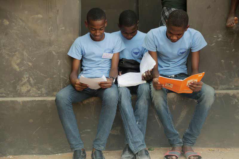 Three teenage boys read together