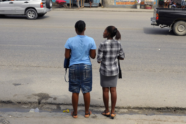Two women standing by a street