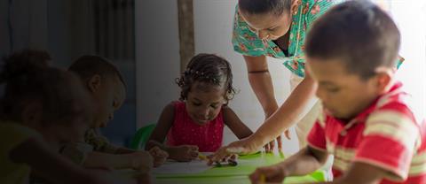 Children sitting at a table and learning