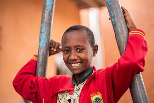 Abel smiles at the camera