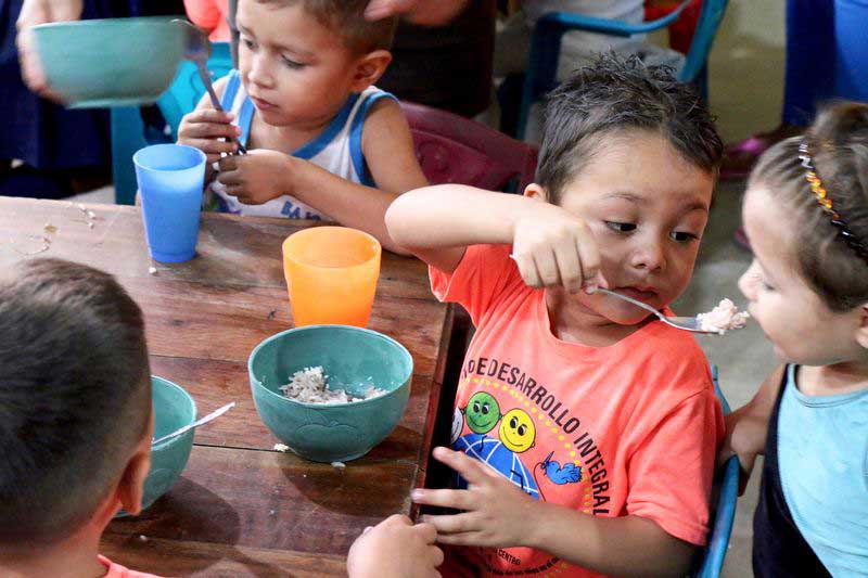 Children share a nutritious meal at their child development center